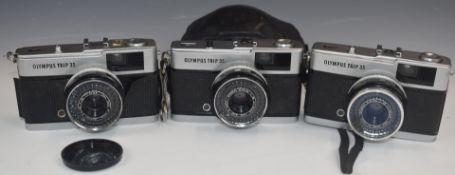 Three Olympus Trip 35 cameras, one with soft case