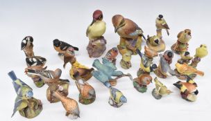 A large collection of Royal Worcester bird figures including woodpecker, jay, blue tits, chaffinches