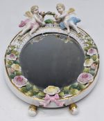 Volkstedt wall mirror with applied figural putti / flower decoration, H27cm