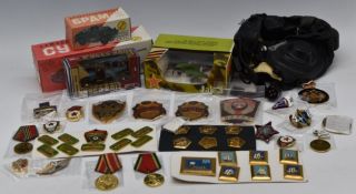 Russian militaria and toys to include flying helmet, badges and medals, circa WWII and later