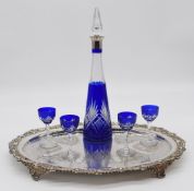 Blue flash overlaid cut glass liqueur set comprising decanter with silver plated mount and four
