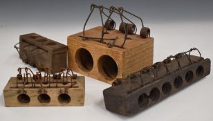Four vintage choke rat and mouse traps including four and six hole versions