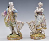 A pair of 19thC continental Vion and Baury figural cornucopia cache/spill holders with script to