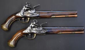 A pair of flintlock holster pistols with Miquelet locks, engraved hammers, pans and top straps,