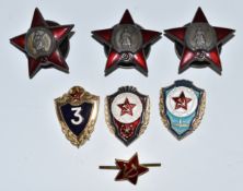 A collection of replica Soviet Order of the Red Star badges etc
