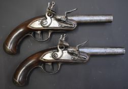 A pair of Queen Anne style French flintlock pistols with bird head grips, steel trigger guards, butt