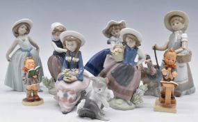 Six Lladro girl figurines, Lladro cat and two Goebel Hummels, tallest 22cm