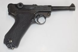 Replica German Luger semi-automatic pistol with chequered composite grips, NVSN, in leather holster.