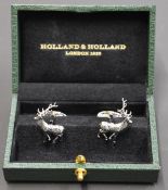 A pair of Holland & Holland stainless steel cufflinks in the form of stags, in original fitted