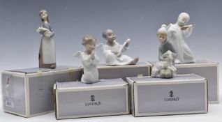 Five Lladro figures angel / putti, girl holding piglet and child with lamb, all boxed, tallest 18cm