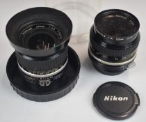 Two Nikon SLR camera lenses comprising 24mm 1:2.8 and 50mm 1:2