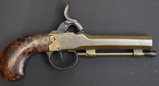 Brass percussion hammer action pocket pistol with engraved frame, walnut grips, wooden tipped