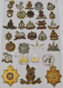 Collection of metal badges including Northumberland Fusiliers, Inniskilling Fusiliers,