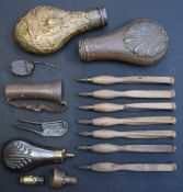 A collection of gun tools and accessories including powder flasks, hand drills and a cutter with
