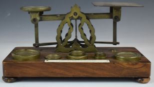 Mordan & Co. Victorian brass postage scales, on wooden base with weights and with postage rates to