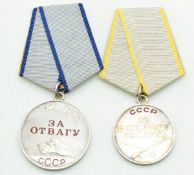 Two Russian medals, one for valour, numbered 3483642 to reverse, the other for combat, numbered