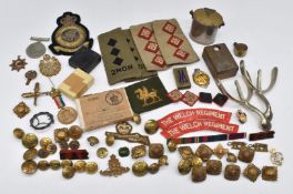 Collection of militaria including trench art, cap badges, buttons, rank insignia etc