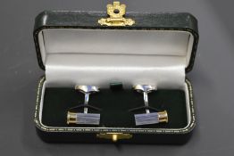 A pair of Holland & Holland stainless steel and gold plated cufflinks in the form of shotgun