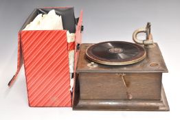 A c1920s oak cased 'table top' wind-up gramophone with a selection of 78rpm shellac records, popular