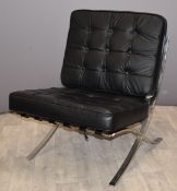 Barcelona style designer chair with chrome or similar frame and black buttoned upholstery