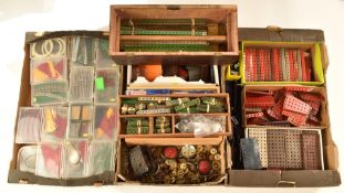 A large collection of loose Meccano parts including wheels, sets, perforated strips, plates, cranks,