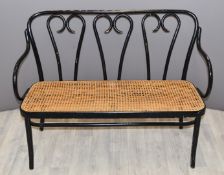 An ebonised bergère bench, L115cm