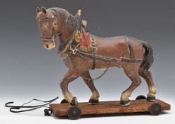 19th or early 20thC child's pull along toy horse, on oak base with small metal wheels, the horse