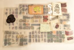 A collection of loose Meccano parts including gears, propeller blades, eccentrics, lifting hooks,