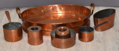 Twin handled copper pan and further copperware, length of large pan 57cm