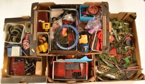 A large collection of loose Meccano parts including clockwork and electric motors, pulleys,