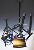 Three guitar stands and various guitar leads including a Fender example