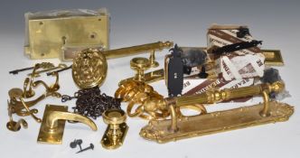 A collection of heavy brass door furniture including a lion mask knob, letterbox, lock with keys,
