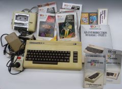 Commodore VIC-20 / VC-20 home computer together with power supply, cassette deck, joystick, manual