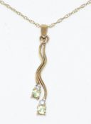 9ct gold pendant set with diamonds and peridots, on 9ct gold chain