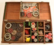 A collection of loose Meccano parts including digger bucket, wheels, gears, bearings, boilers, chain