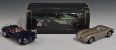 Three 1:18 scale die-cast models comprising Autoart Jaguar XK SS, Jaguar C-Type and Hotwheels 2000
