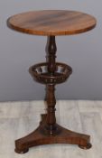 Victorian rosewood circular side table with revolving undershelf raised on a turned support and