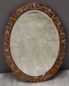 Arts and Crafts copper framed mirror with vine or similar decoration and with bevelled glass,