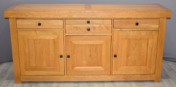 A contemporary light oak sideboard fitted four drawers and three cupboards, W188 x D48 x H91cm