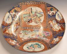Japanese Meiji period Imari charger decorated with figural scenes, flowers and gilt dragons, 69cm in