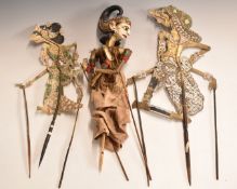 Three Indonesian Wayang Kulit shadow puppets, largest 65cm tall.