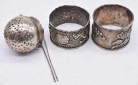 Wang Hing Chinese silver napkin ring, further napkin ring and an unmarked Eastern silver tea