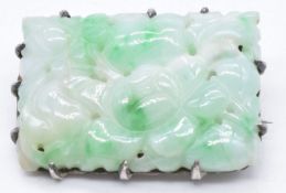 Chinese white metal brooch set with a carved jade panel, 35 x 25mm