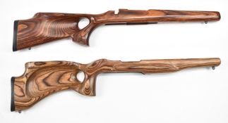 Two laminated show wood target rifle stocks, both with thumb hole grips, raised cheek pieces and