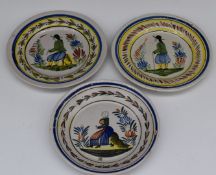 Three 19thC Quimper faience wall plaques with figural decoration, diameter 23cm