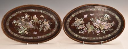 Pair of Chinese mother of pearl inlaid oval rosewood panels, 22 x 32cm