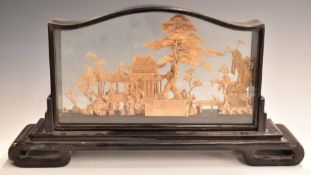 Chinese carved cork picture in glazed case on carved wooden stand, 49.5x26.5x10cm