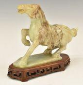 Chinese carved jadeite or similar hardstone horse on wooden base, 18cm tall.