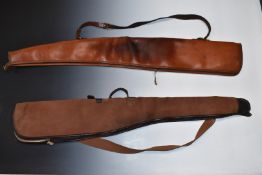 Two shotgun slips, one leather sheepskin lined the other canvas and leather.