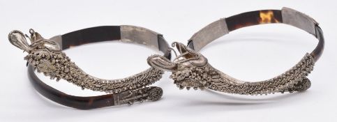 A pair of late 19th/ 20thC silver filigree and tortoiseshell bracelets, each in the form of a dragon
